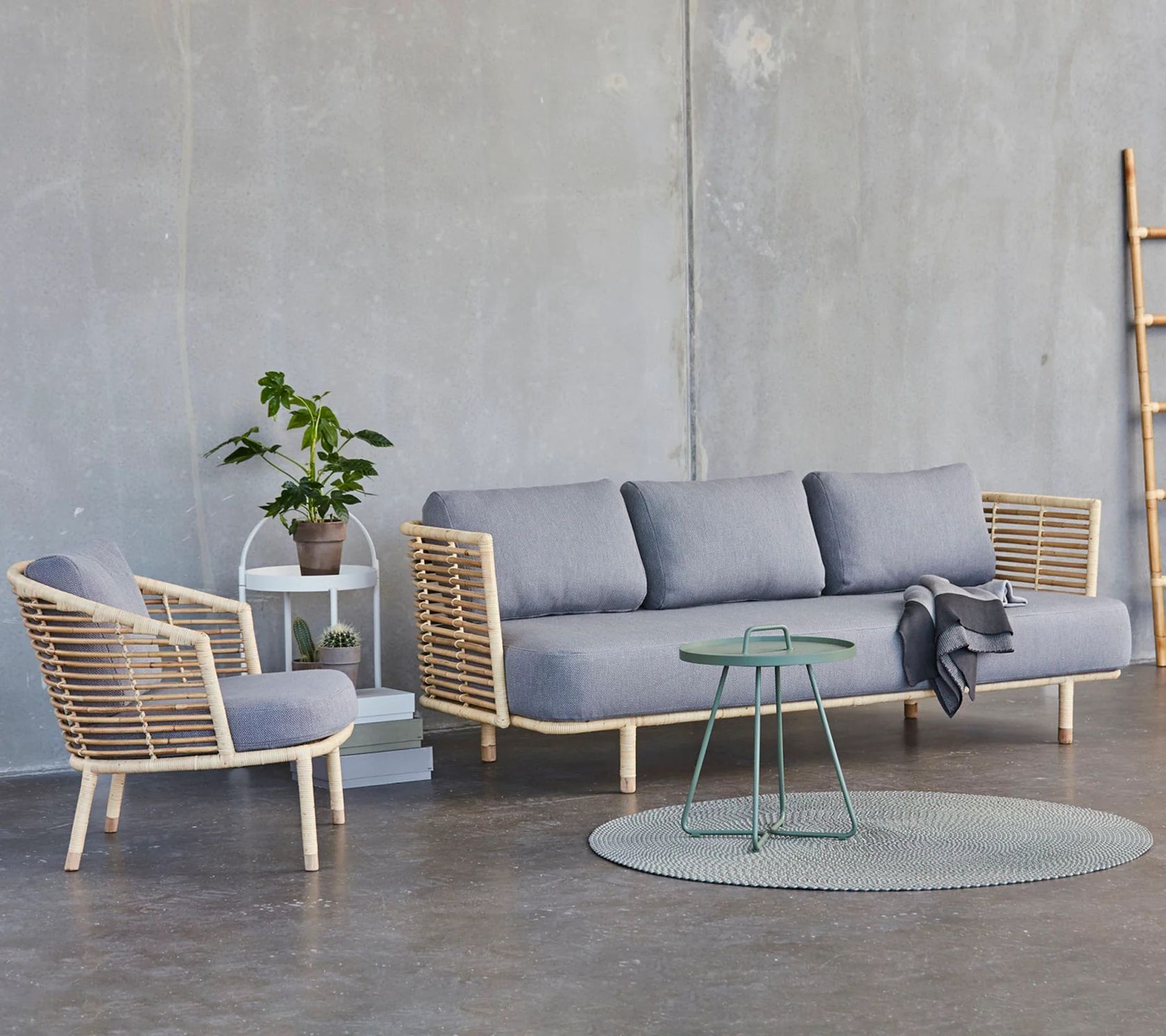 Cane-line Sense outdoor lounge sofa in Cane-line Weave on a terrace