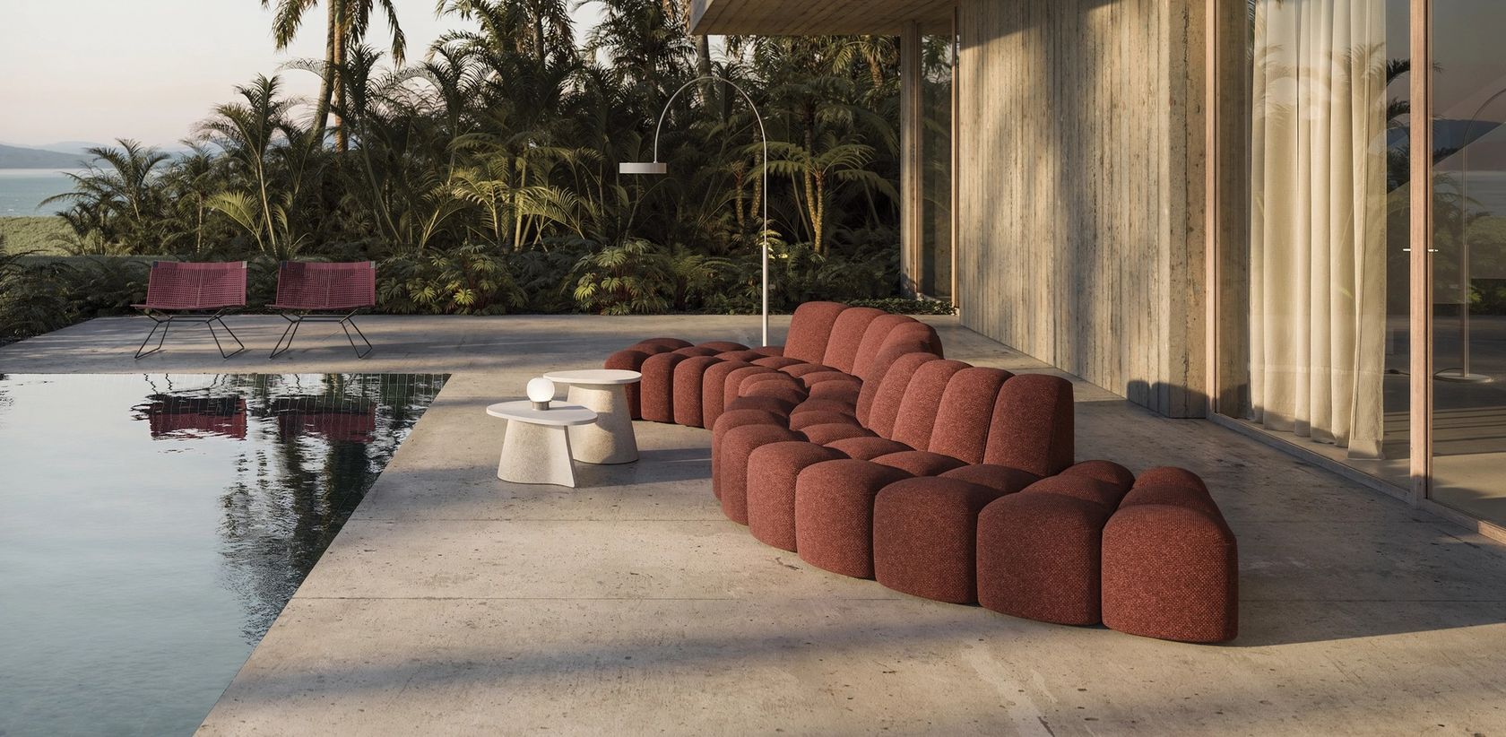 An MDF Italia outdoor terrace setting with a modular sofa beside a pool, no people