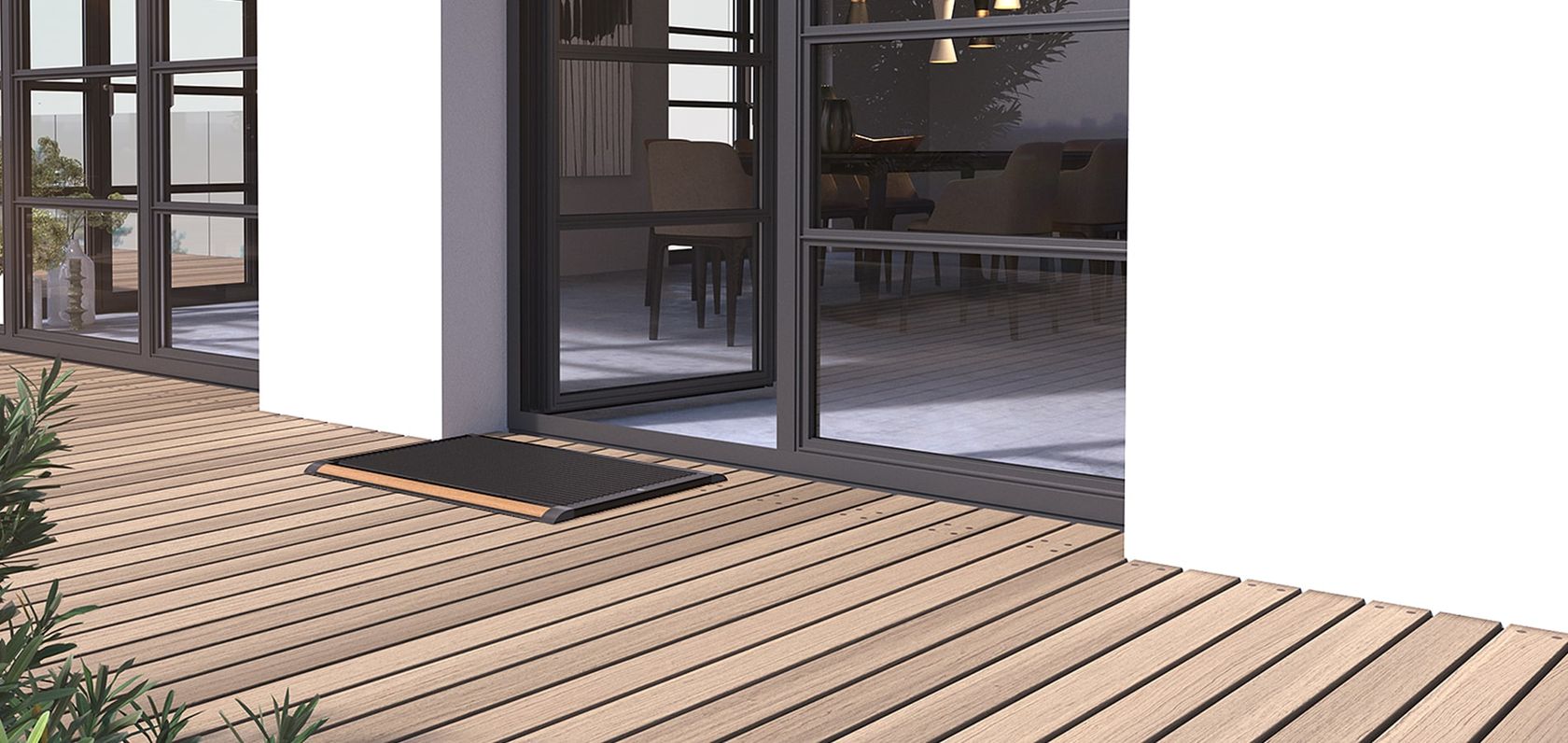 A RiZZ design doormat with a teak inlay set into a wood terrace beside open patio doors, no people